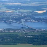 Ariel view of the forth bridges crossing the Firth of Forth near South Queensferry, including the Queensferry Crossing, Forth Road Bridge and Forth Bridge.