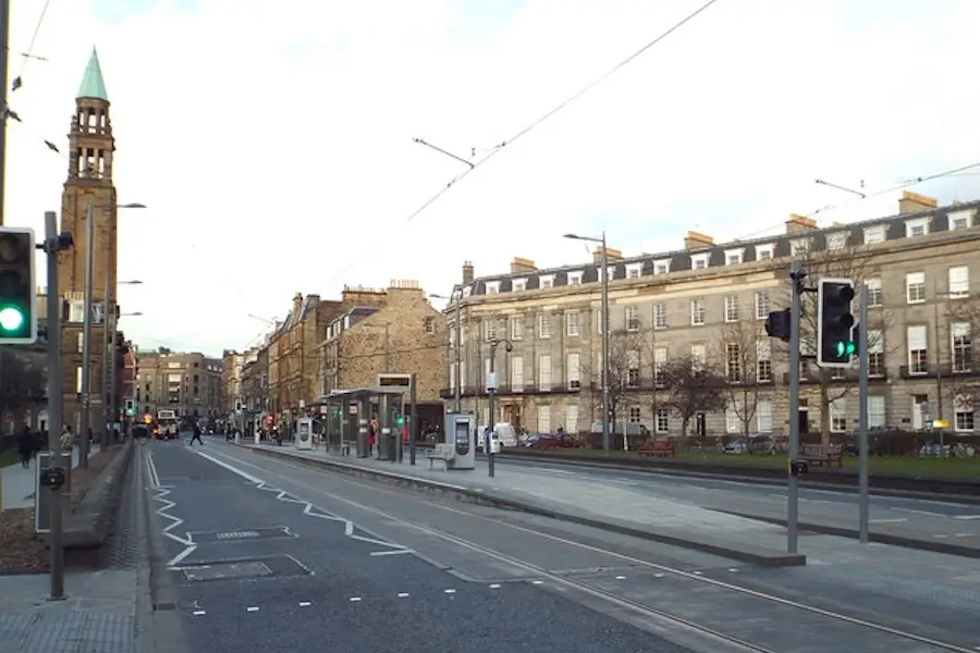 Shandwick Place tram stop in Edinburgh’s New Town, showing tram tracks, traffic lights, looking toward Princes Street and Georgian buildings along the street.