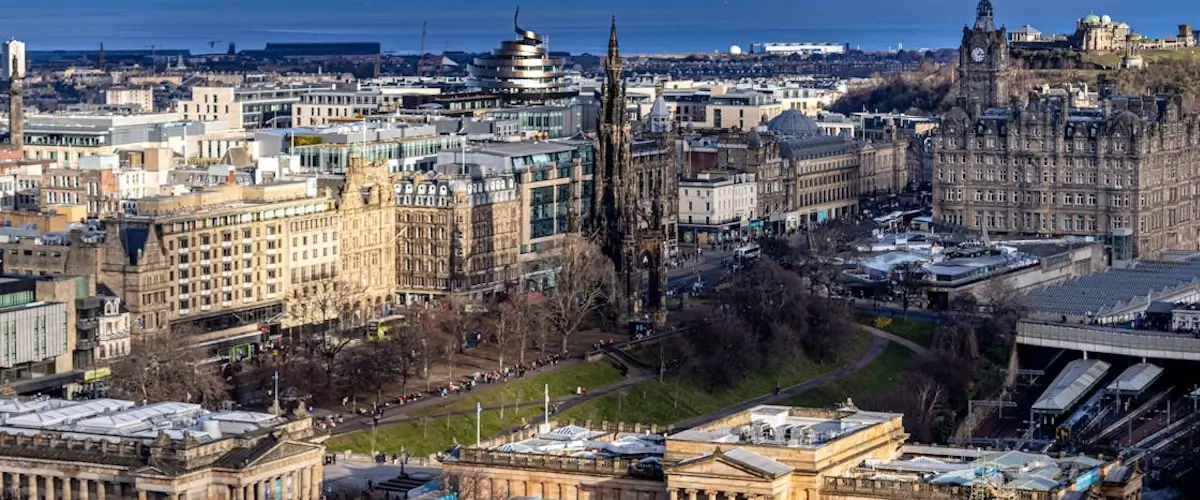 aerial shot of new town and princes street showing balmoral hotel st james quarter and firth of forth