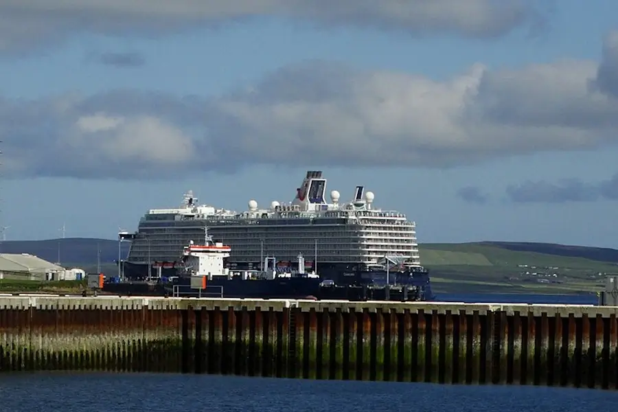 Scotland cruise guide image showing a cruise ship docked at Kirkwall harbour in Orkney