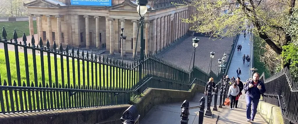 tired visitors climbing steep steps between princes street and Edinburgh old ton