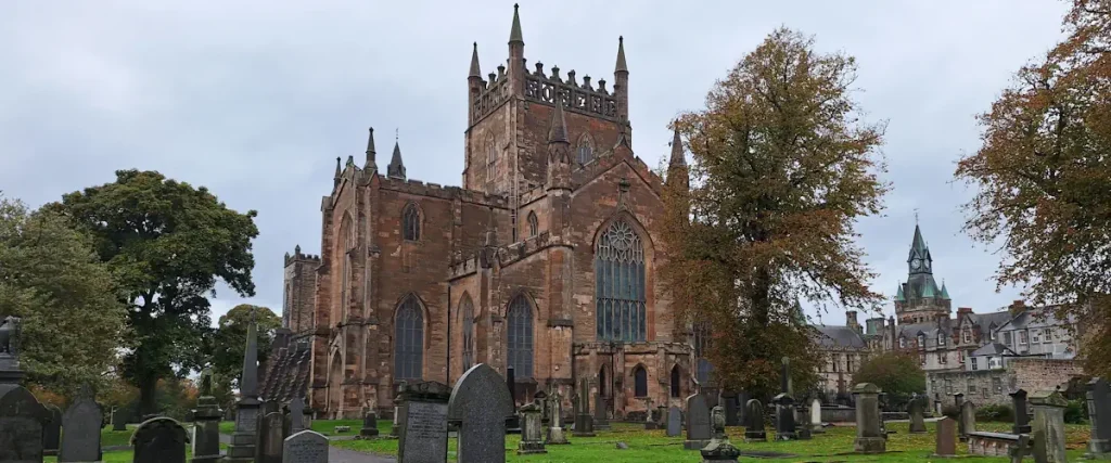 Dunfermline Abbey and Palace seen across the abbey graveyard, with the church tower and nave