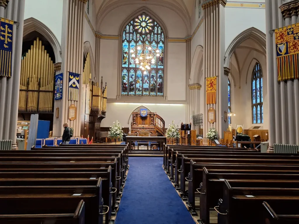 Inside Dunfermline Abbey Church, looking along the pews towards the stained glass window