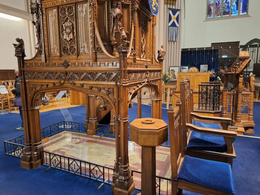 Carved wooden pulpit in Dunfermline Abbey Church beside Robert the Bruce’s memorial brass